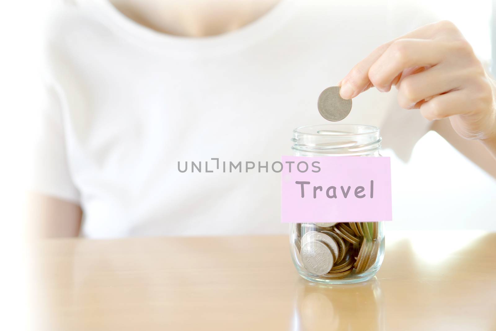 Woman hands with coins in glass jar, close up by ekachailo