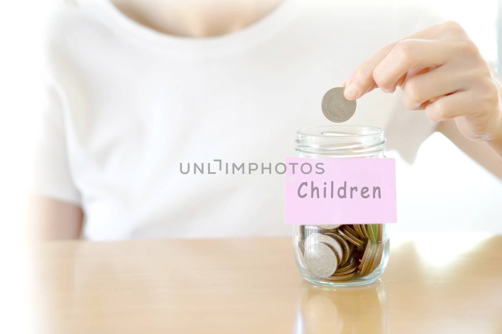 Woman hands with coins in glass jar, close up by ekachailo