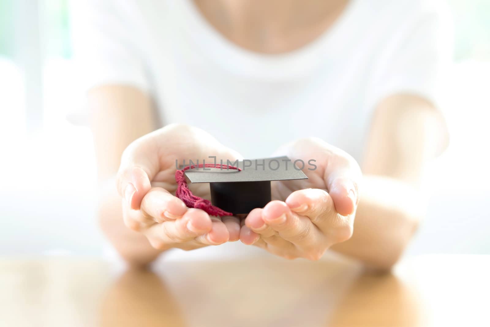 Woman holding a mortar board 