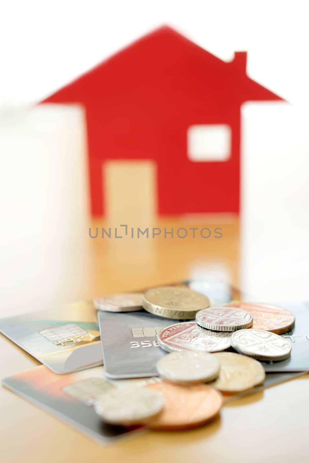 Real estate investment by credit card. House and coins