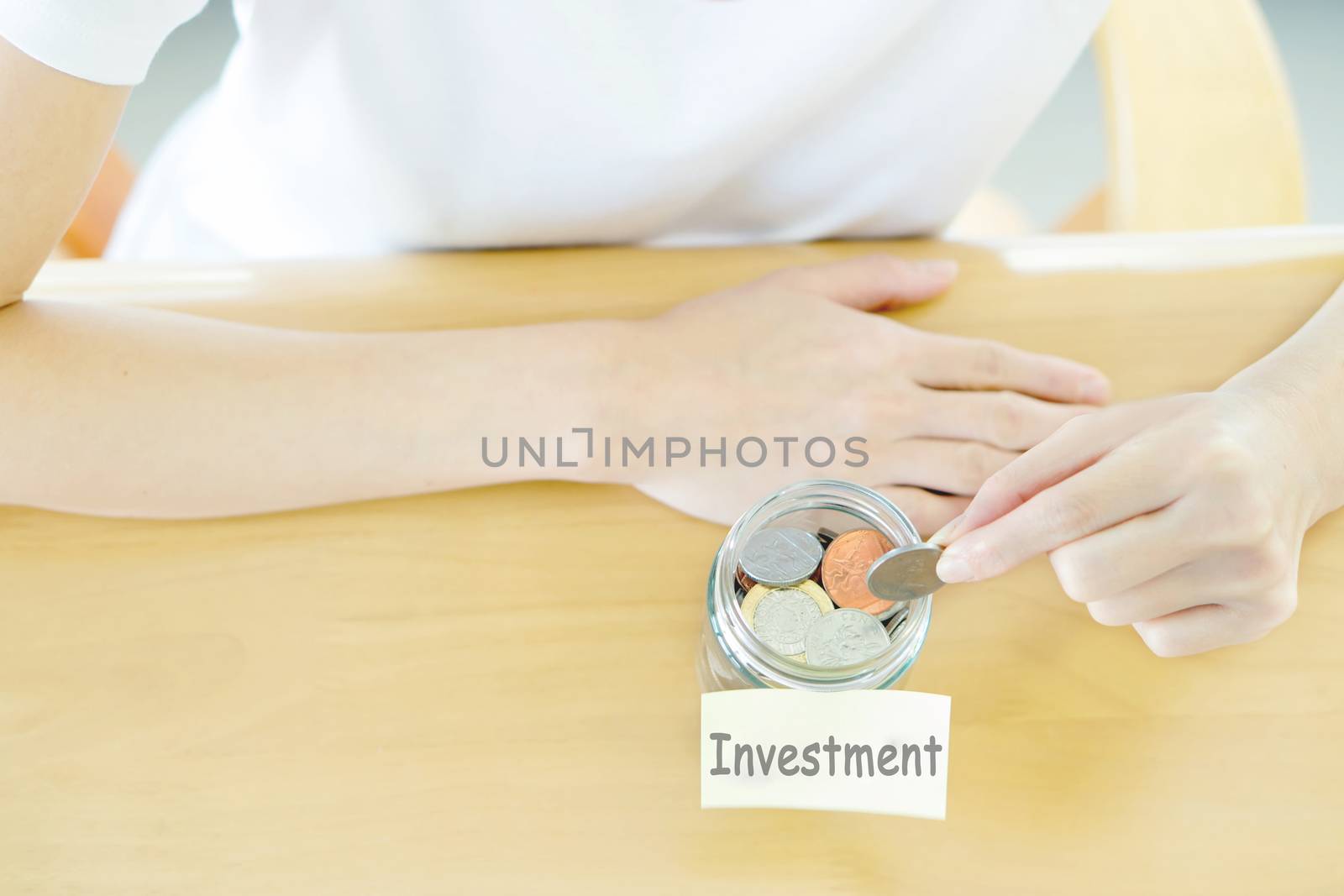 Woman hands with coins in glass jar, top view by ekachailo