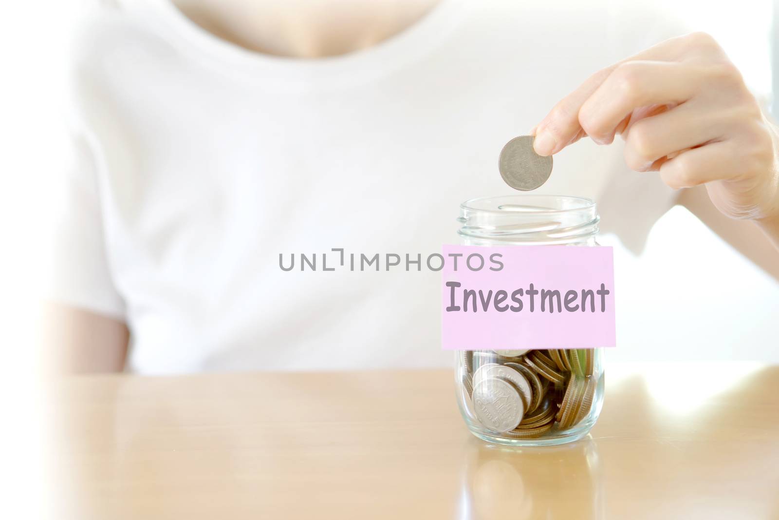 Woman hands with coins in glass jar, close up by ekachailo