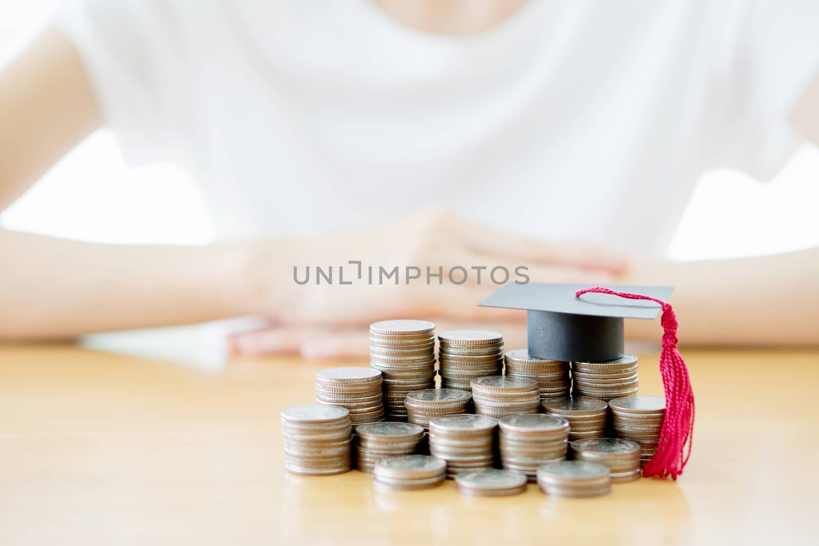 Woman saving education coins by ekachailo