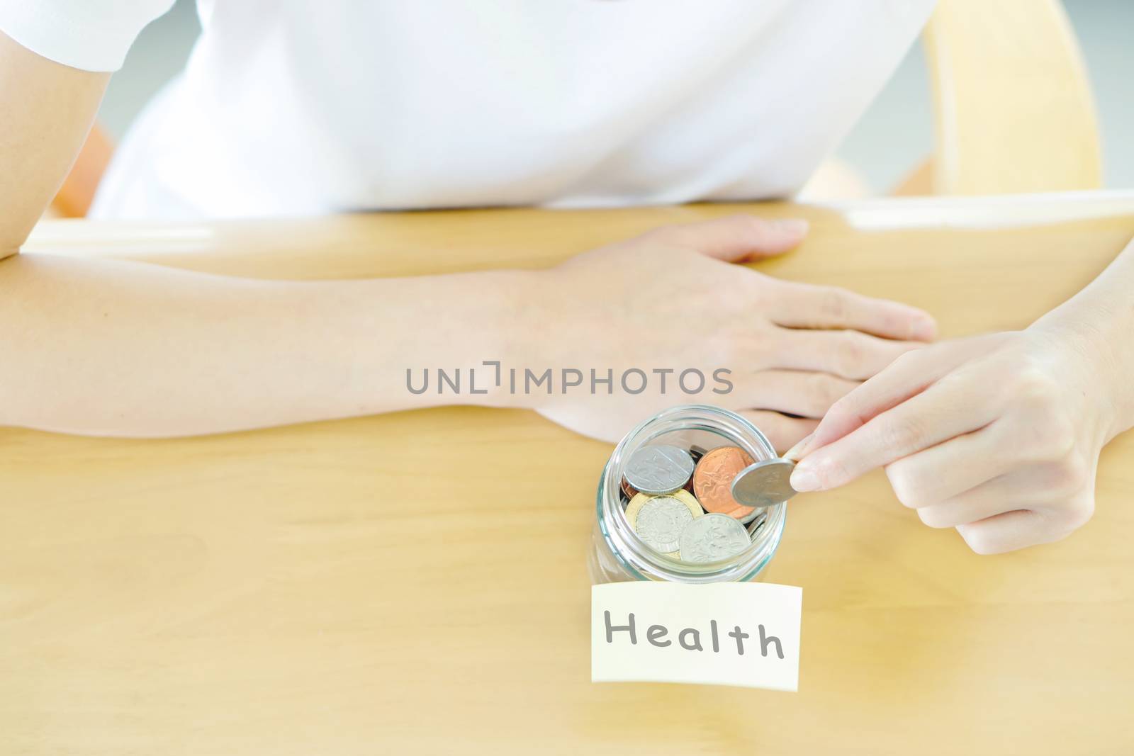 Woman hands with coins in glass jar, top view by ekachailo