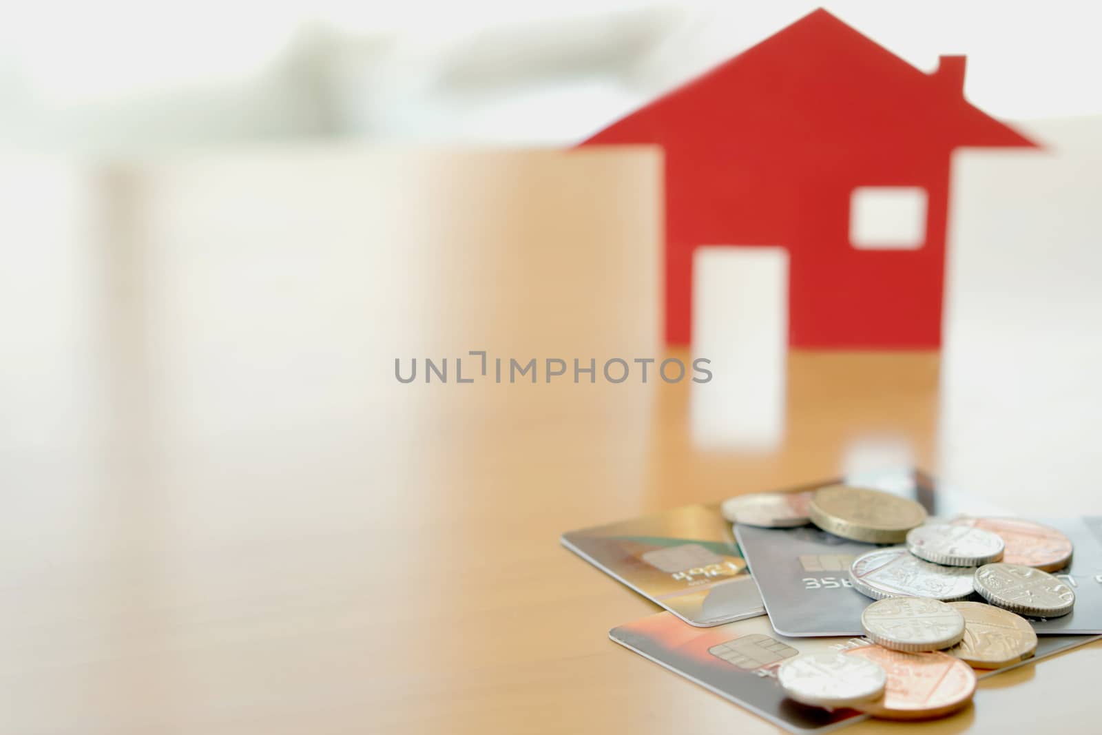 Real estate investment by credit card. House and coins by ekachailo