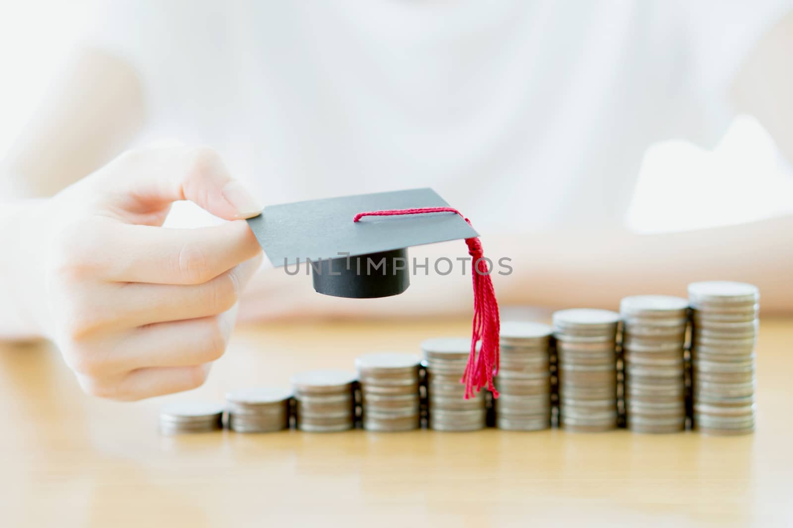 Woman saving education coins by ekachailo