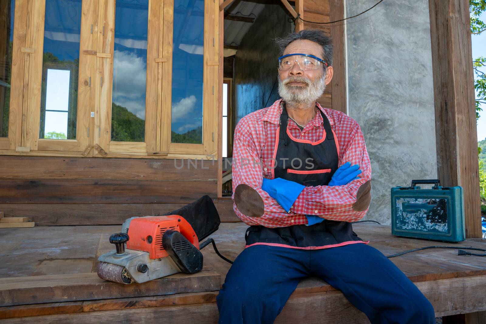 Senior man carpenter,Old carpenter working in carpentry workshop.