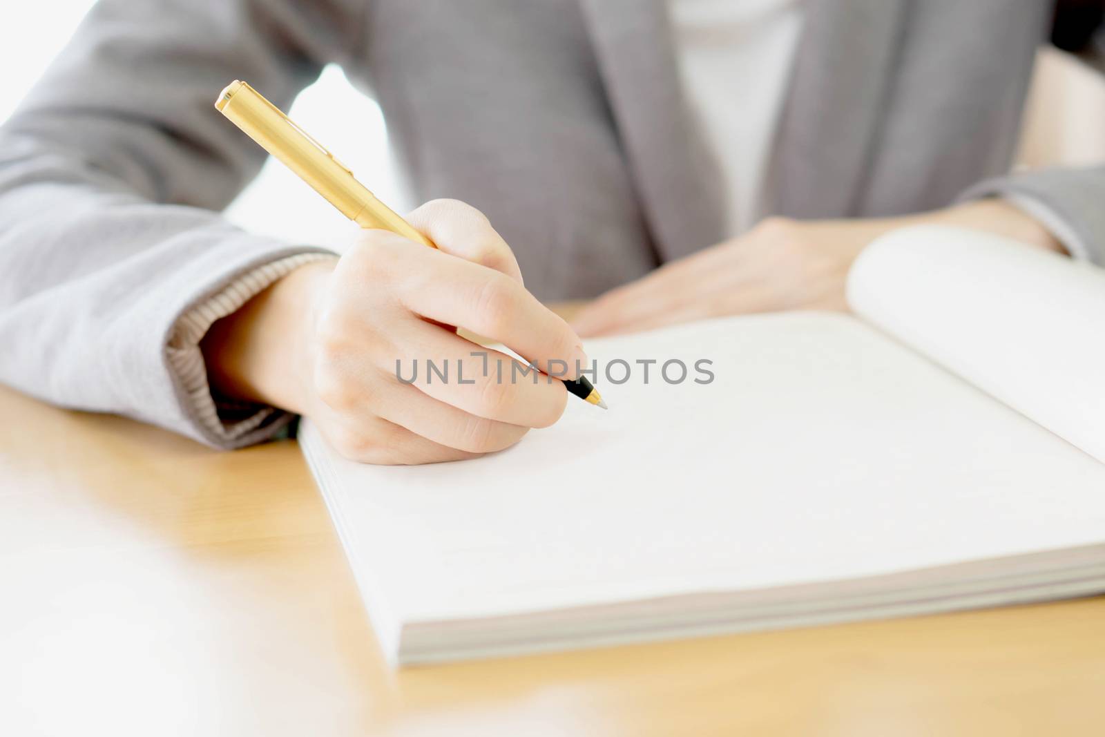 Woman writing on paper by ekachailo