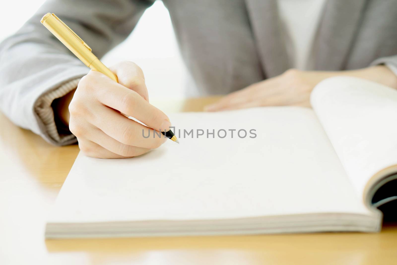 Woman writing on paper by ekachailo