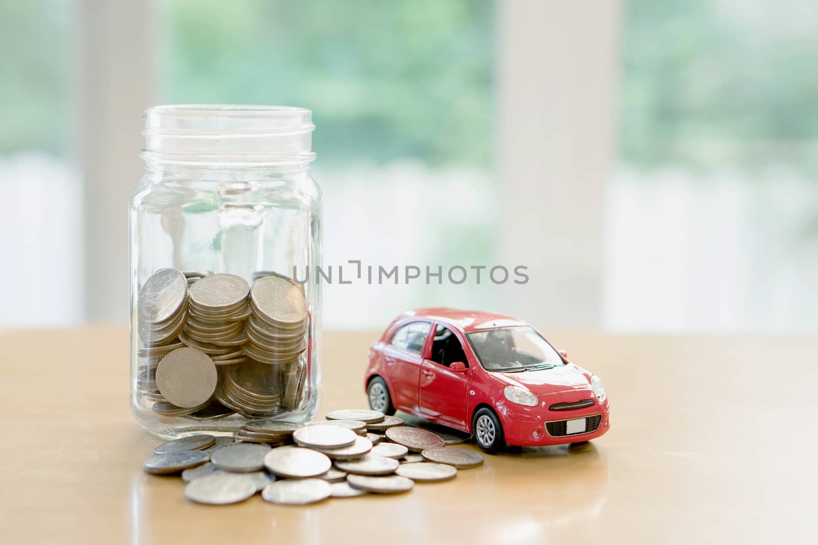 Education budget concept. Car money savings in a glass