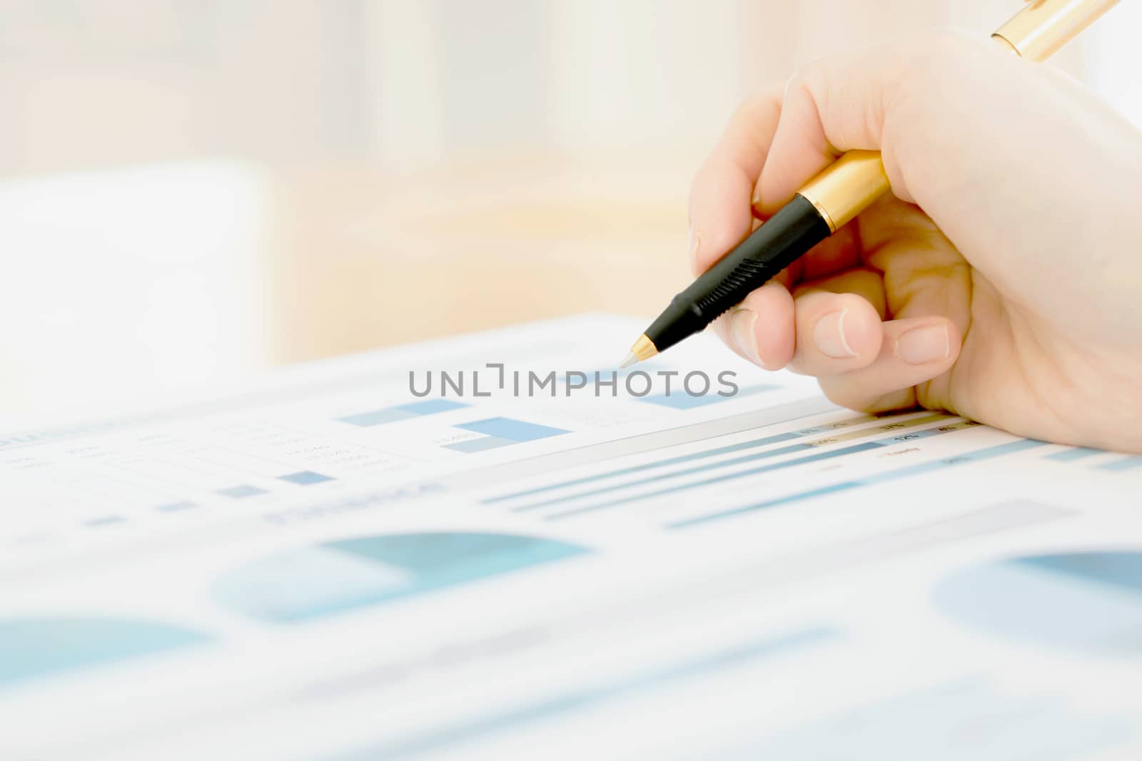 Businesswoman holding a pen and analyze data