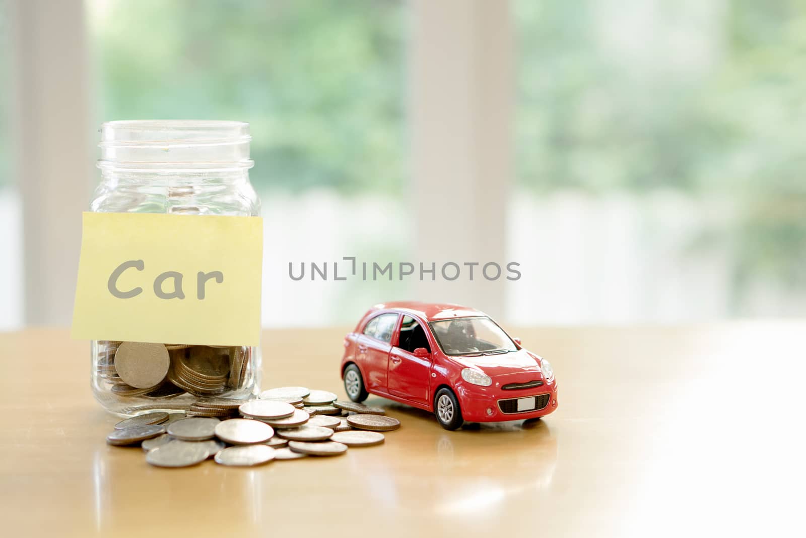 Education budget concept. Car money savings in a glass by ekachailo