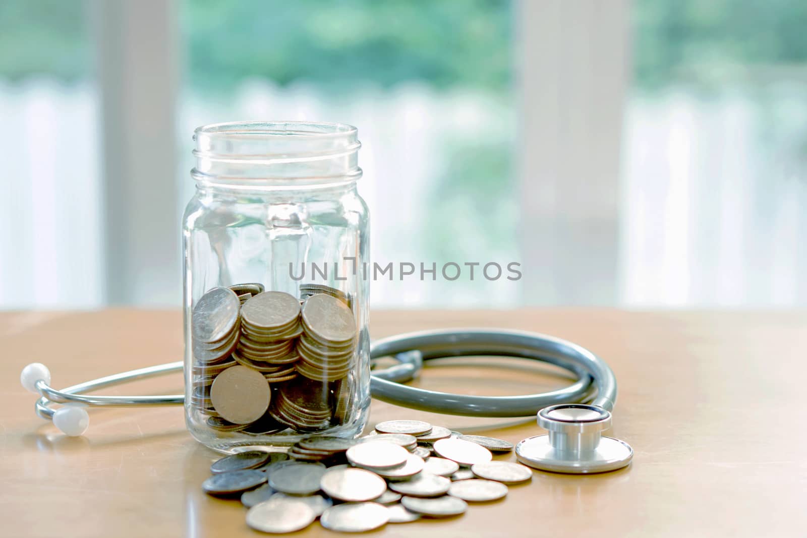 Education budget concept. stethoscopes money savings in a glass by ekachailo