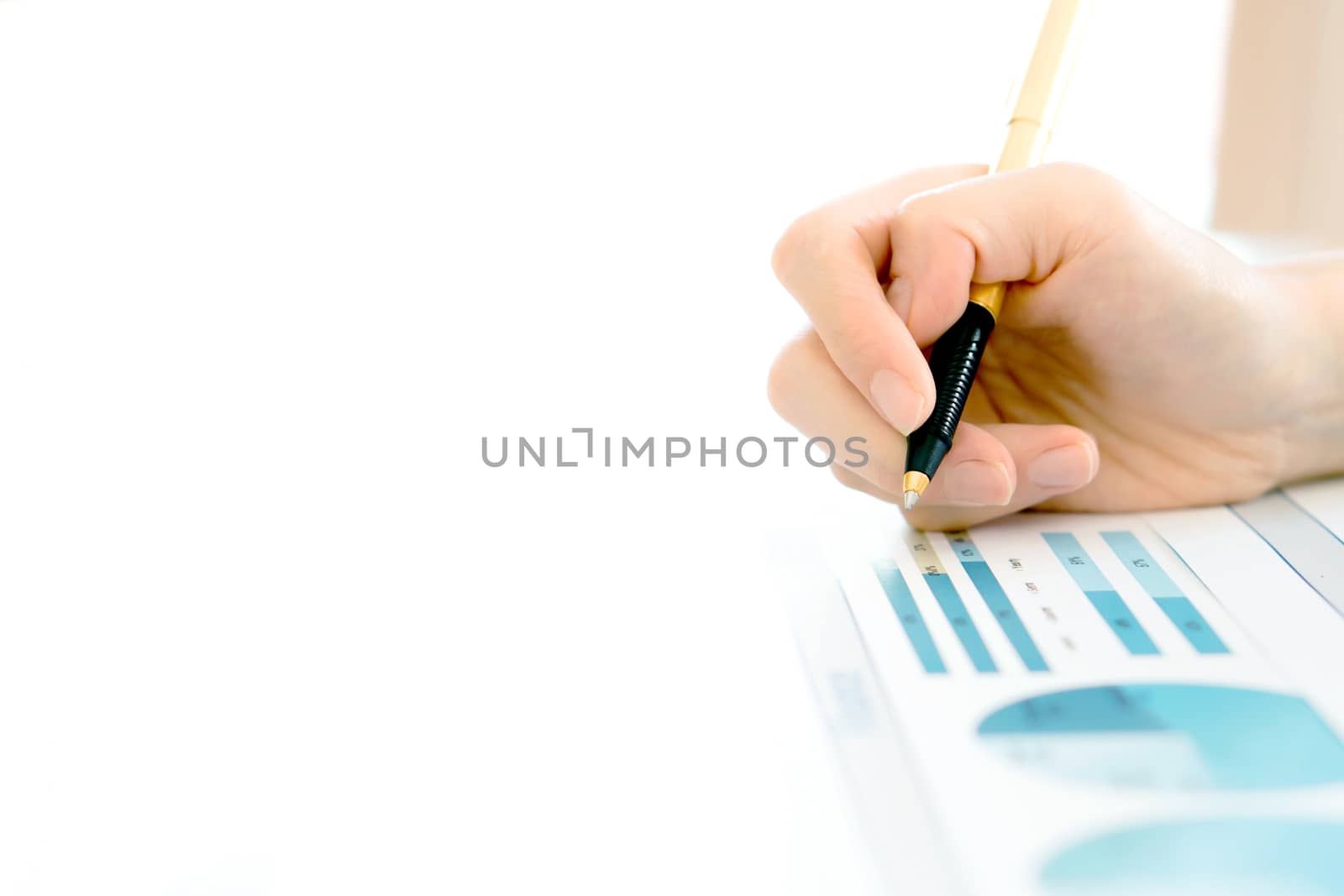 Businesswoman holding a pen and analyze data