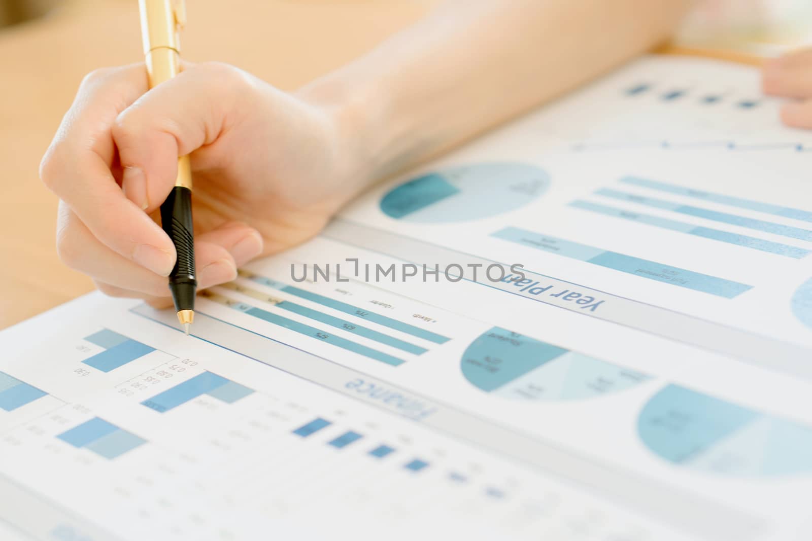 Businesswoman Analyzing Financial Graph With Coins  by ekachailo