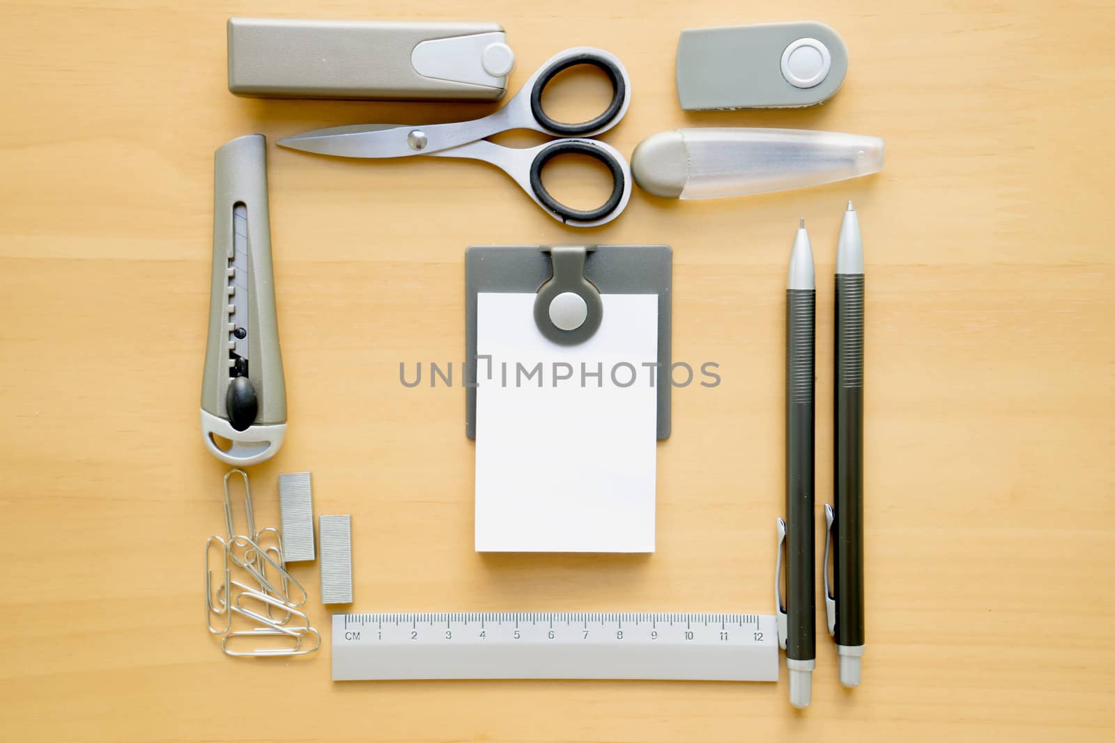 Open album with school supplies on the wooden table