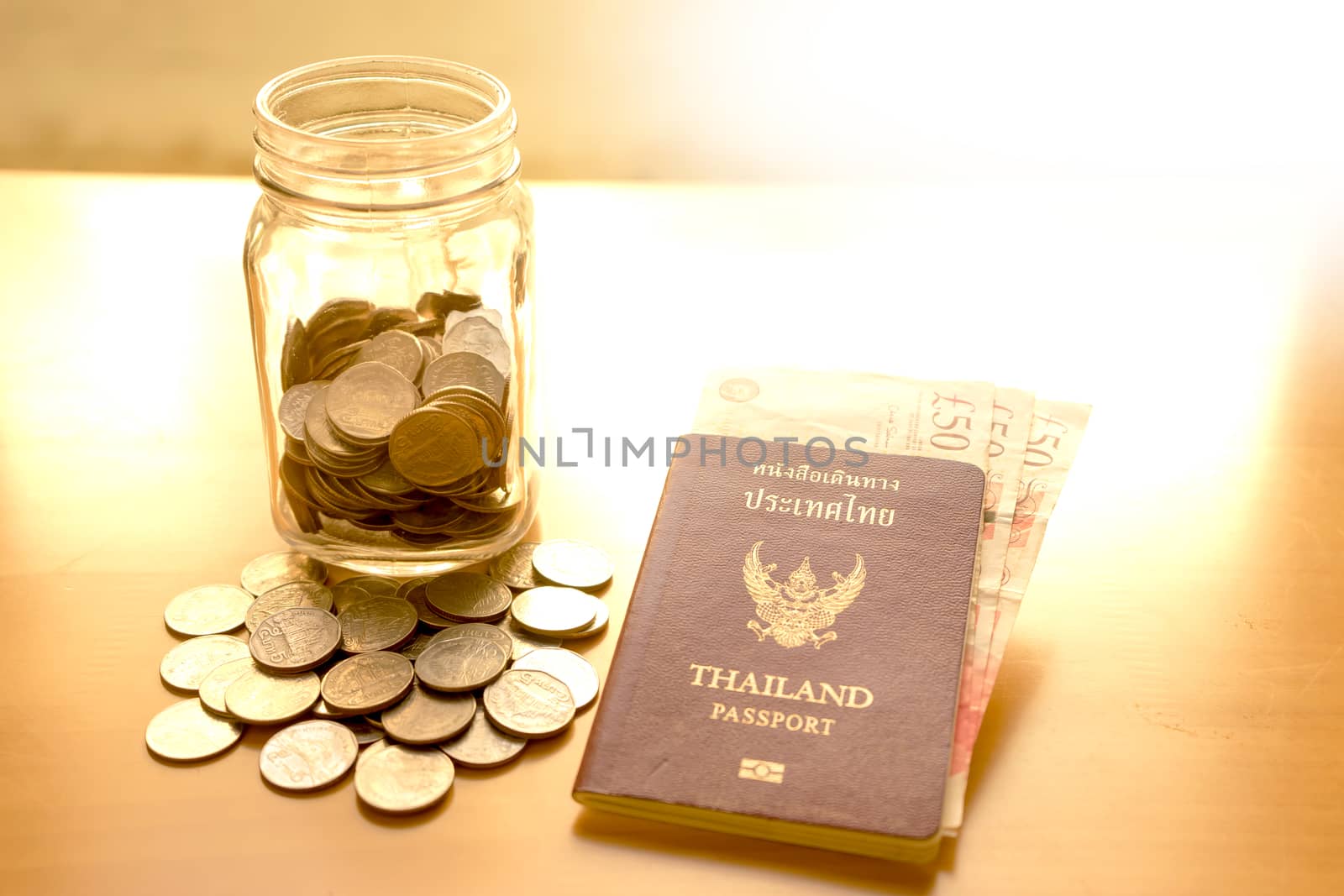 Savings jar with currency for travel 