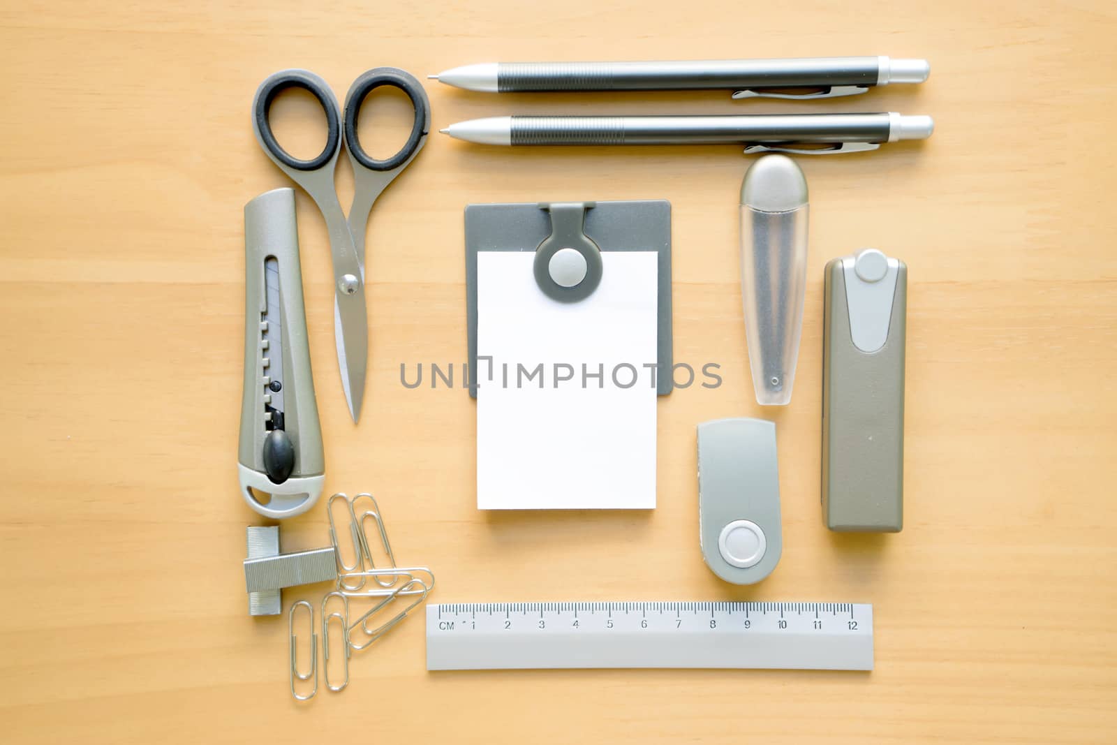 Open album with school supplies on the wooden table