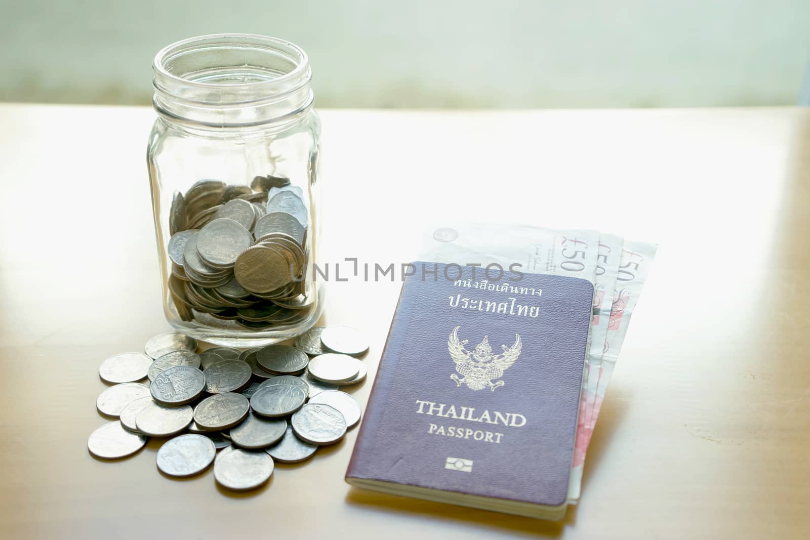 Savings jar with currency for travel by ekachailo