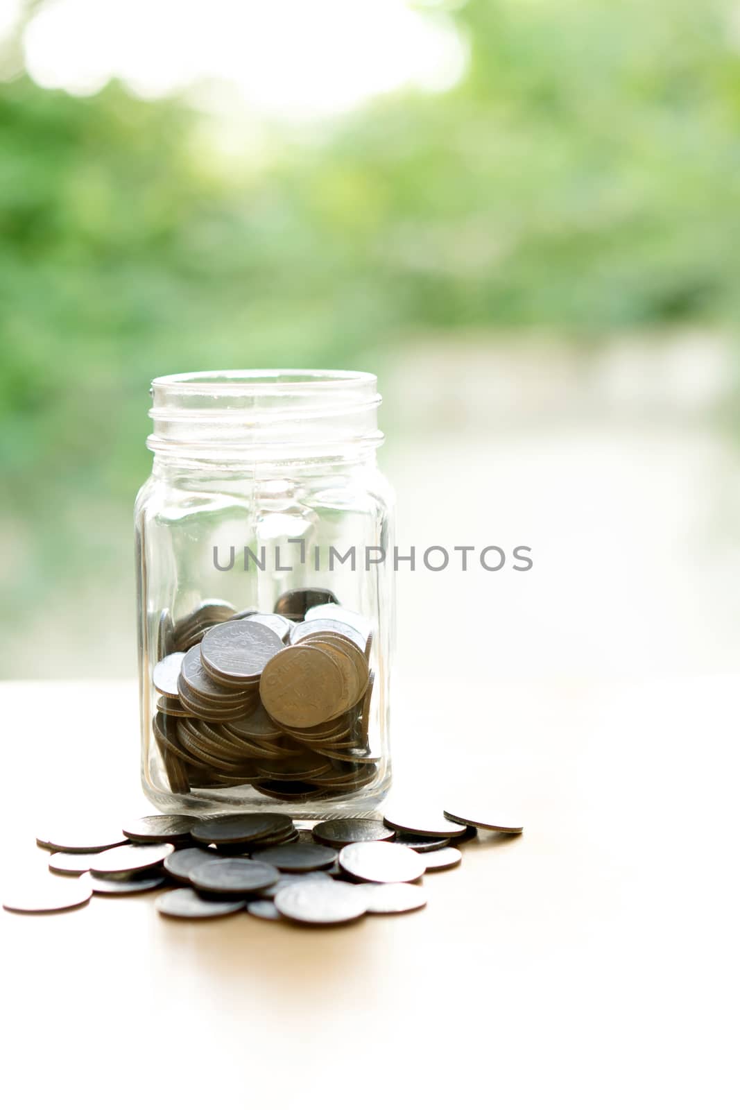 Coins Into Glass Jar by ekachailo