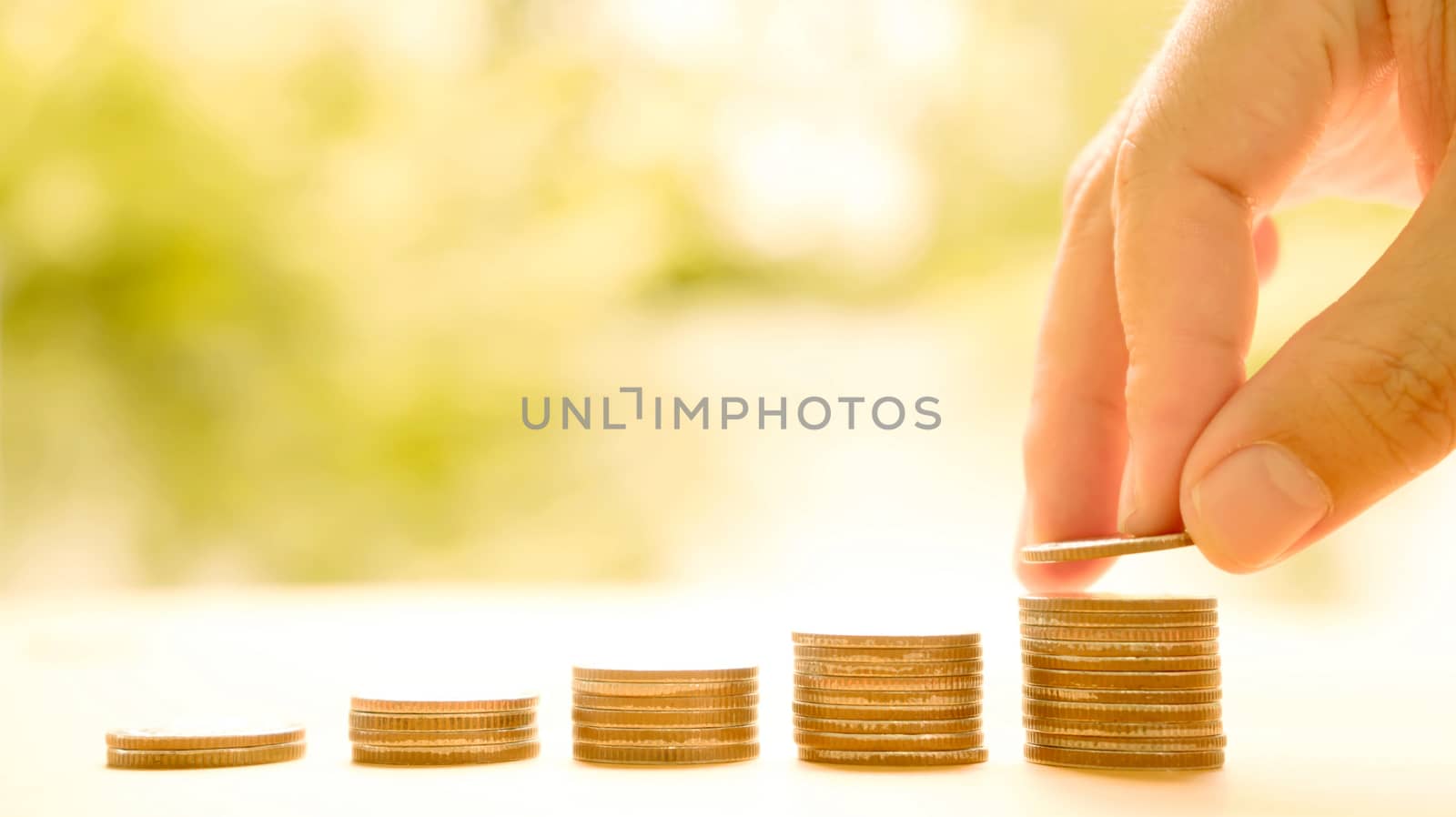 hand put money coins to stack of coins. Money, Financial, Business Growth concept.