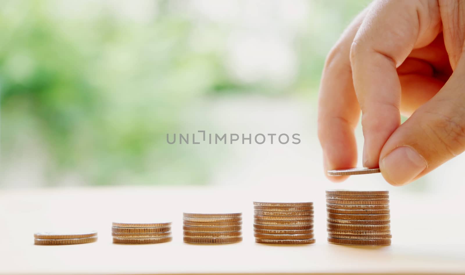 hand put money coins to stack of coins. Money, Financial, Business Growth concept.