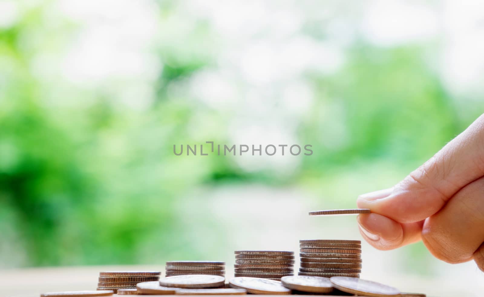 hand put money coins to stack of coins. Money, Financial, Business Growth concept.