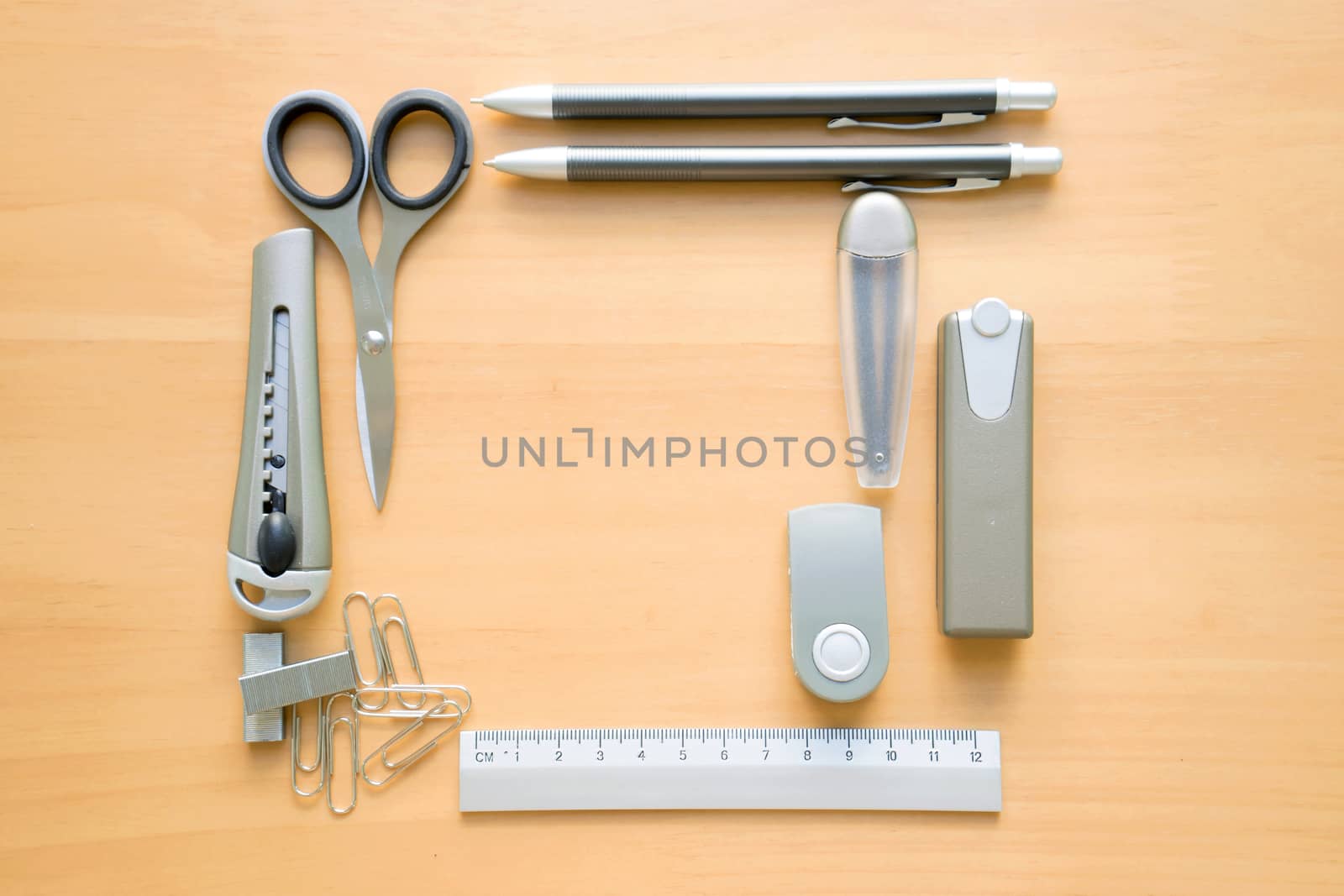 Open album with school supplies on the wooden table