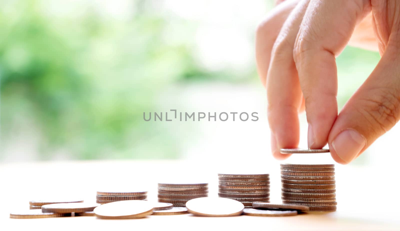 hand put money coins to stack of coins. Money, Financial, Business Growth concept.