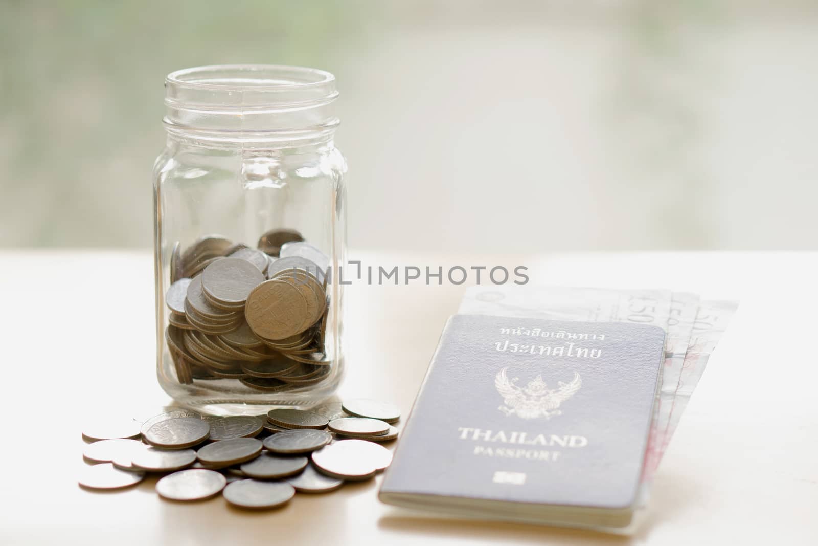 Savings jar with currency for travel