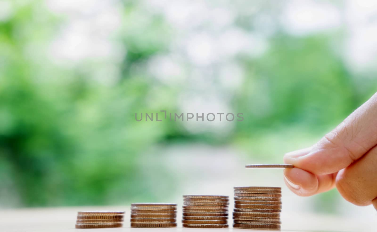 hand put money coins to stack of coins. Money, Financial, Business Growth concept.