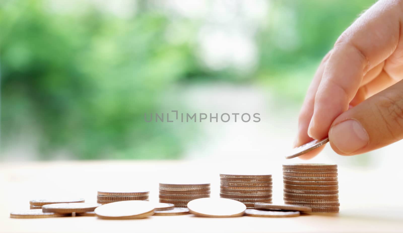 hand put money coins to stack of coins. Money, Financial, Business Growth concept.