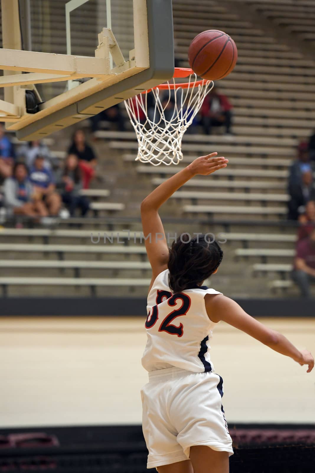 Girl shooting a basketball lay up with the caption: "My Game"