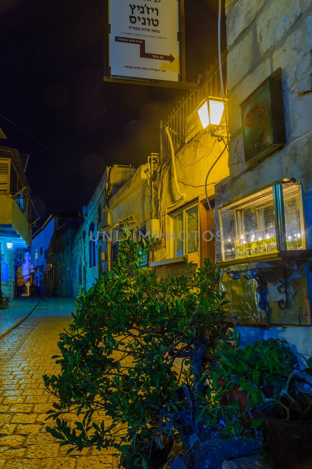 SAFED, ISRAEL - DECEMBER 16, 2017: Traditional Menorah (Hanukkah Lamp) with olive oil candles, in an alley in the Jewish quarter, in Safed (Tzfat), Israel