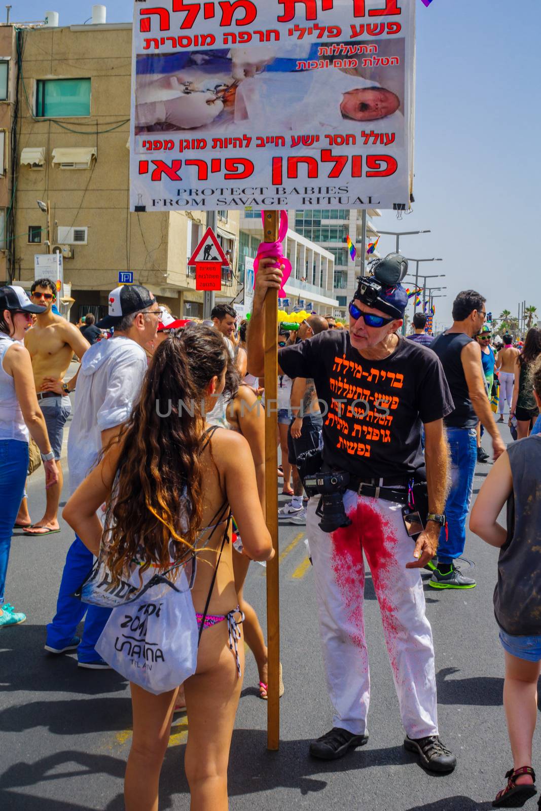 TEL-AVIV, ISRAEL - JUNE 03, 2016: A protestor against circumcision speaks to the crowd, in the Pride Parade in the streets of Tel-Aviv, Israel. Its part of an annual event of the LGBT community