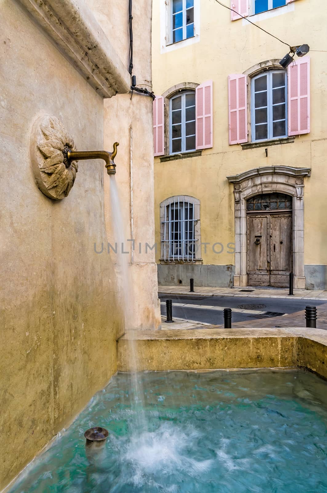 A fountain flowing fresh water in the town of Brignoles in Provence, south of France