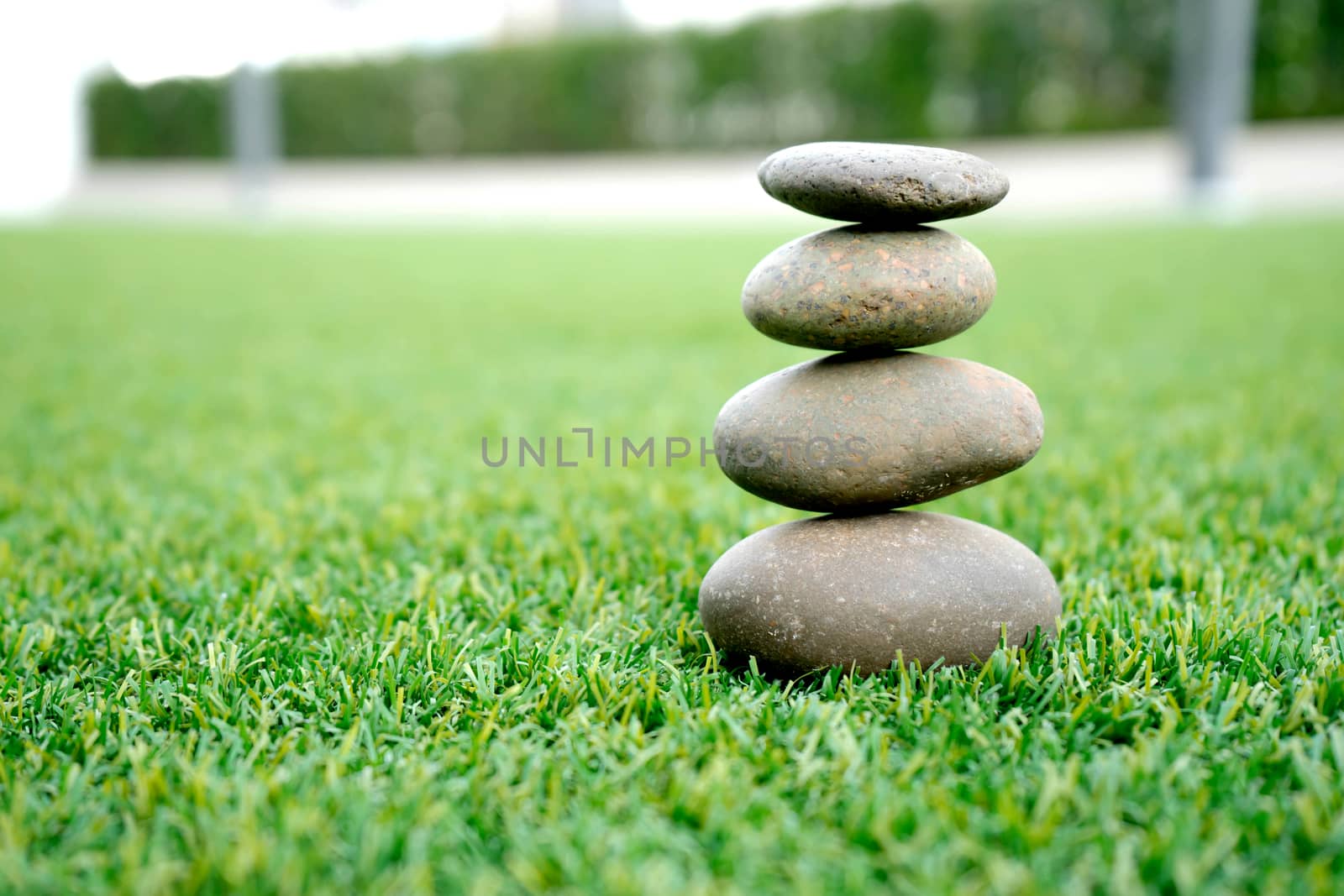stones stacked up on grass 