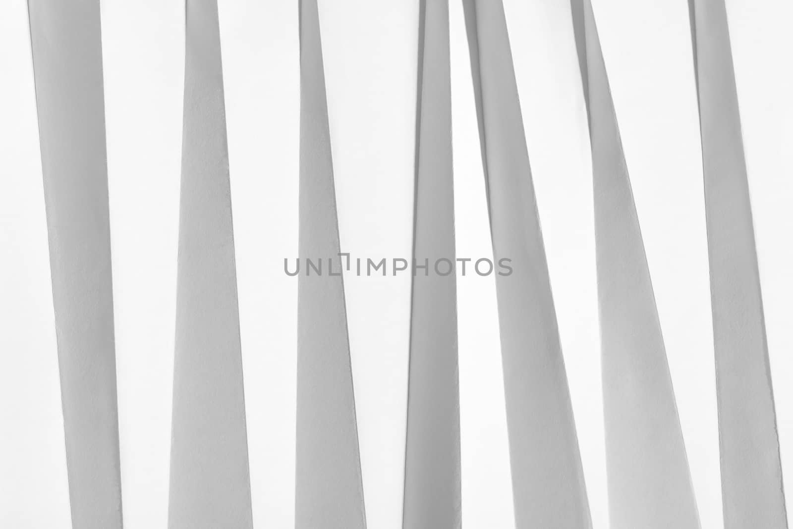 White folded sheet of paper showing an abstract texture design under the light grazing. Good to use as background