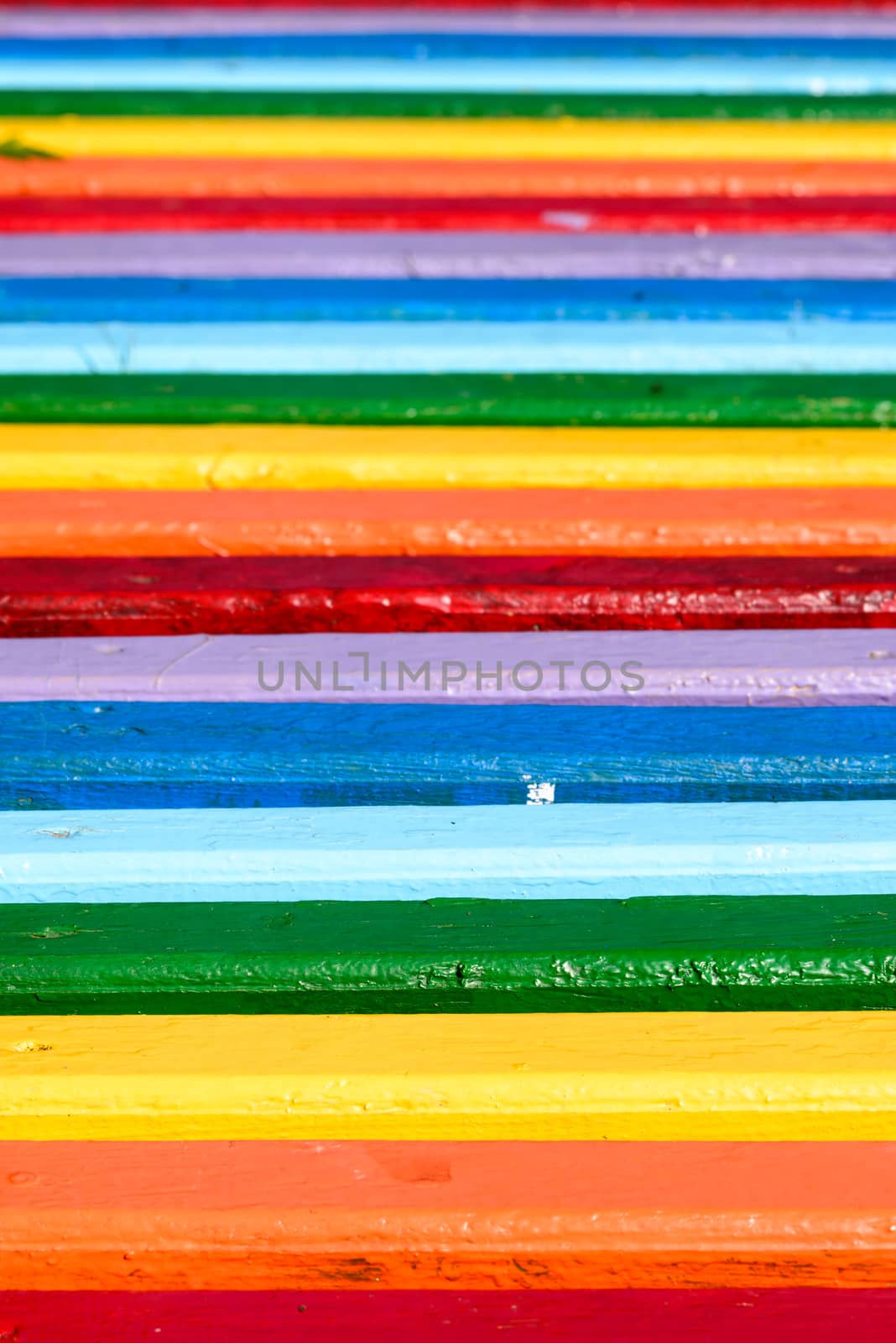 A multicolored wooden bench in the park