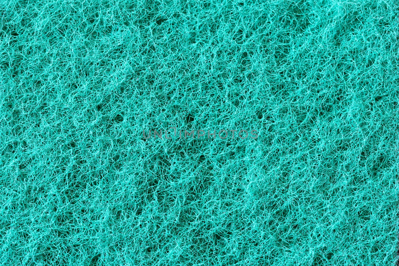 Macro of green synthetic sponge texture, scrub side