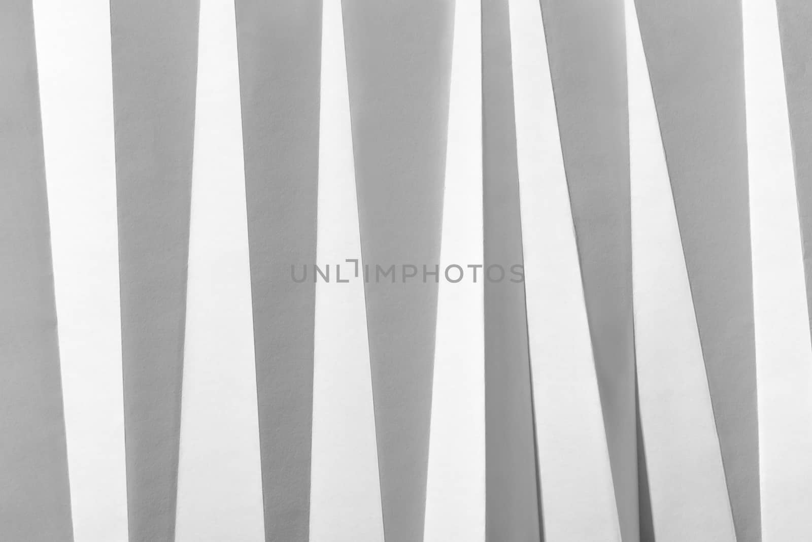 White folded sheet of paper showing an abstract texture design under the light grazing. Good to use as background