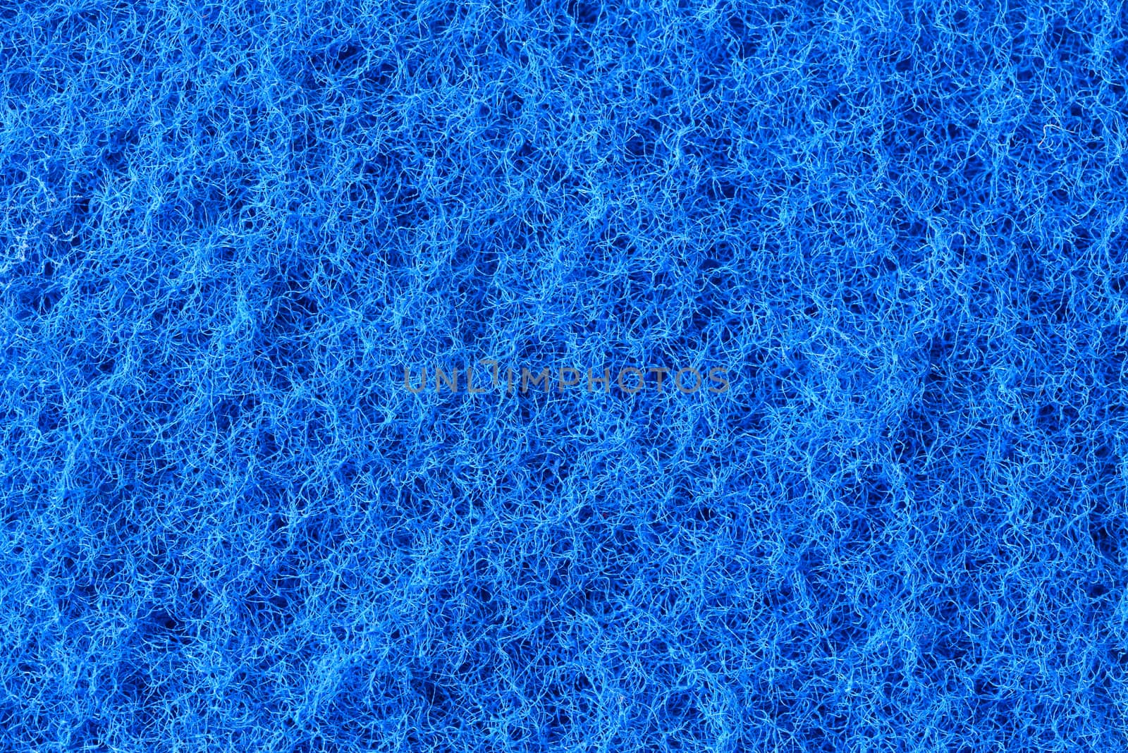 Macro of blue synthetic sponge texture, scrub side