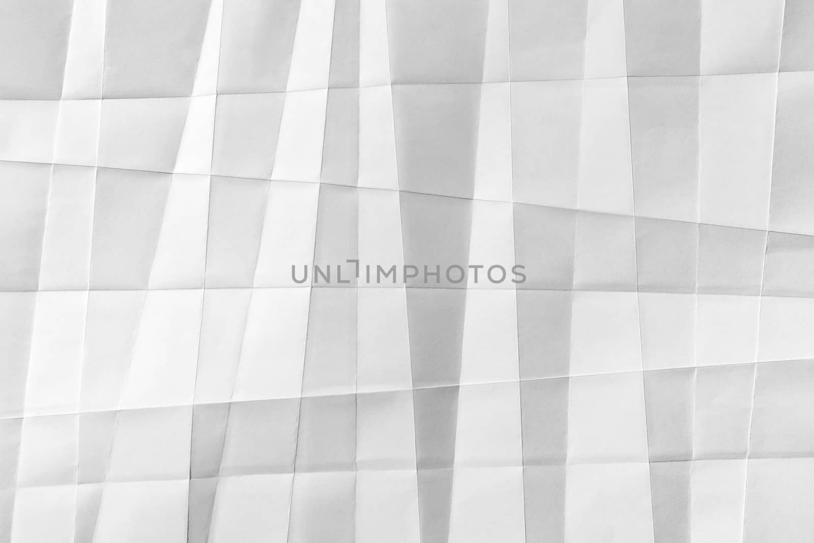 White folded sheet of paper showing an abstract texture design under the light grazing. Good to use as background