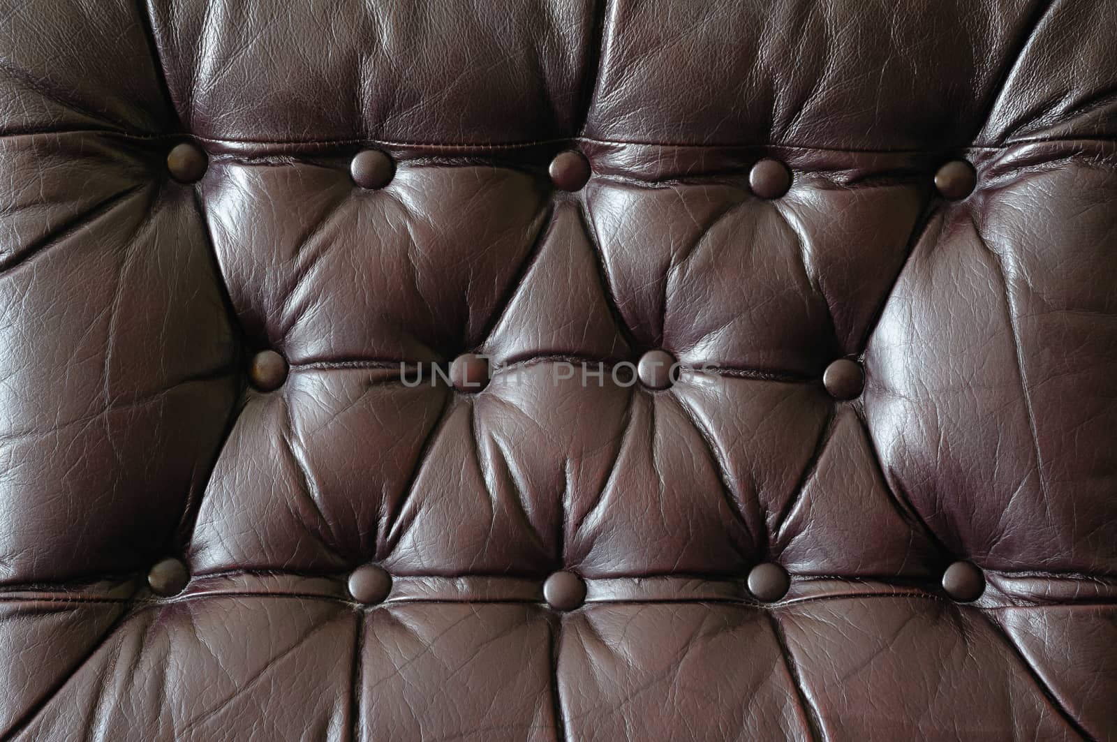 A detail of an old leather couch