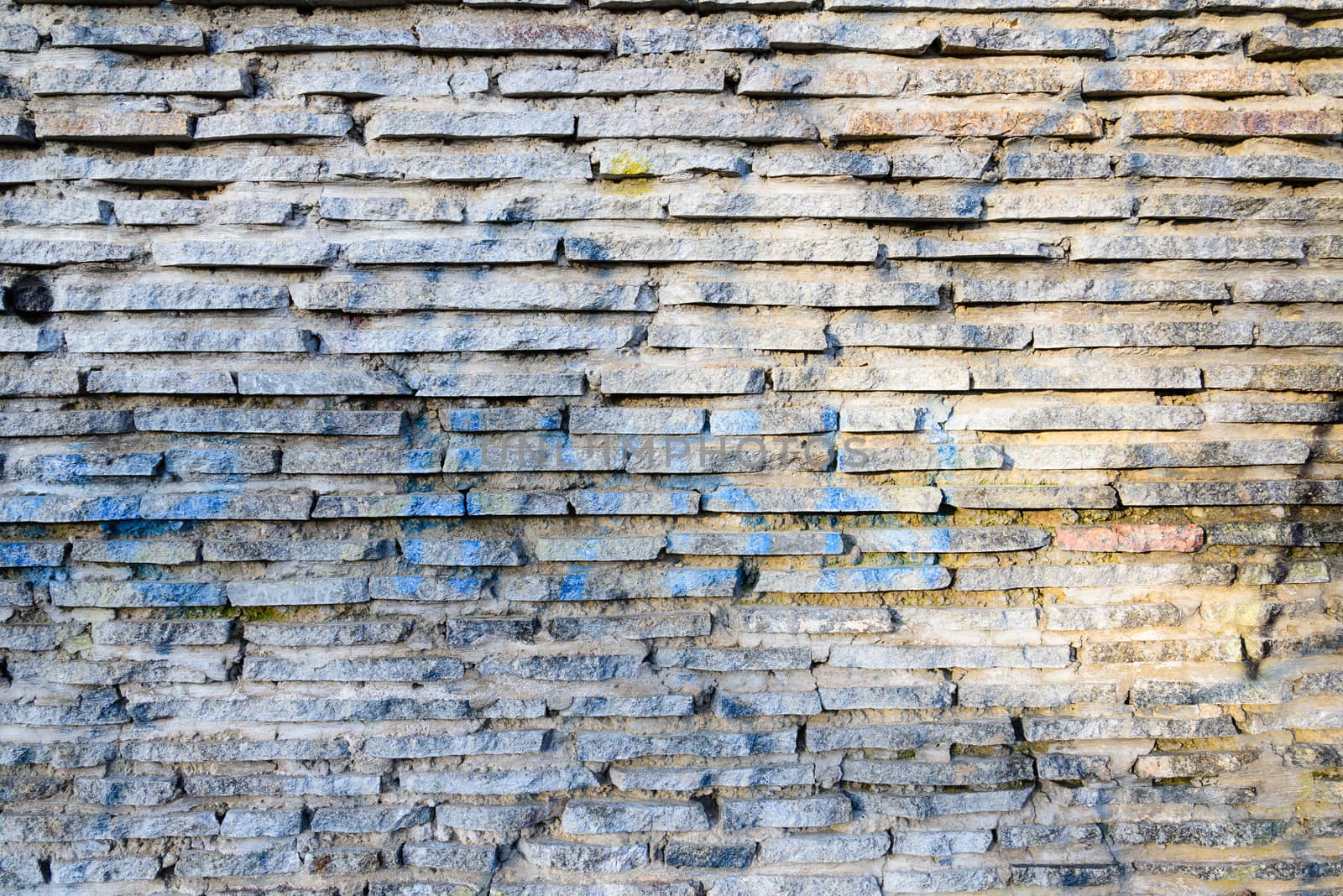 Stone wall texture under a changing light