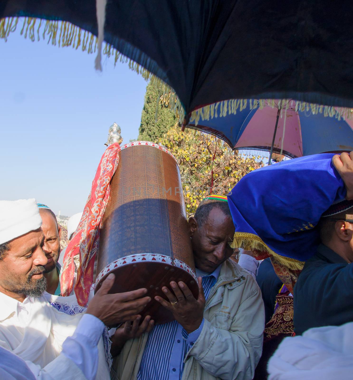 JERUSALEM - NOV 20, 2014: An Ethiopian Jewish man and a Kes, religious leader of the Ethiopian Jews, carrying the holy torah book, at the end of the annual Sigd holiday prays, in Jerusalem, Israel