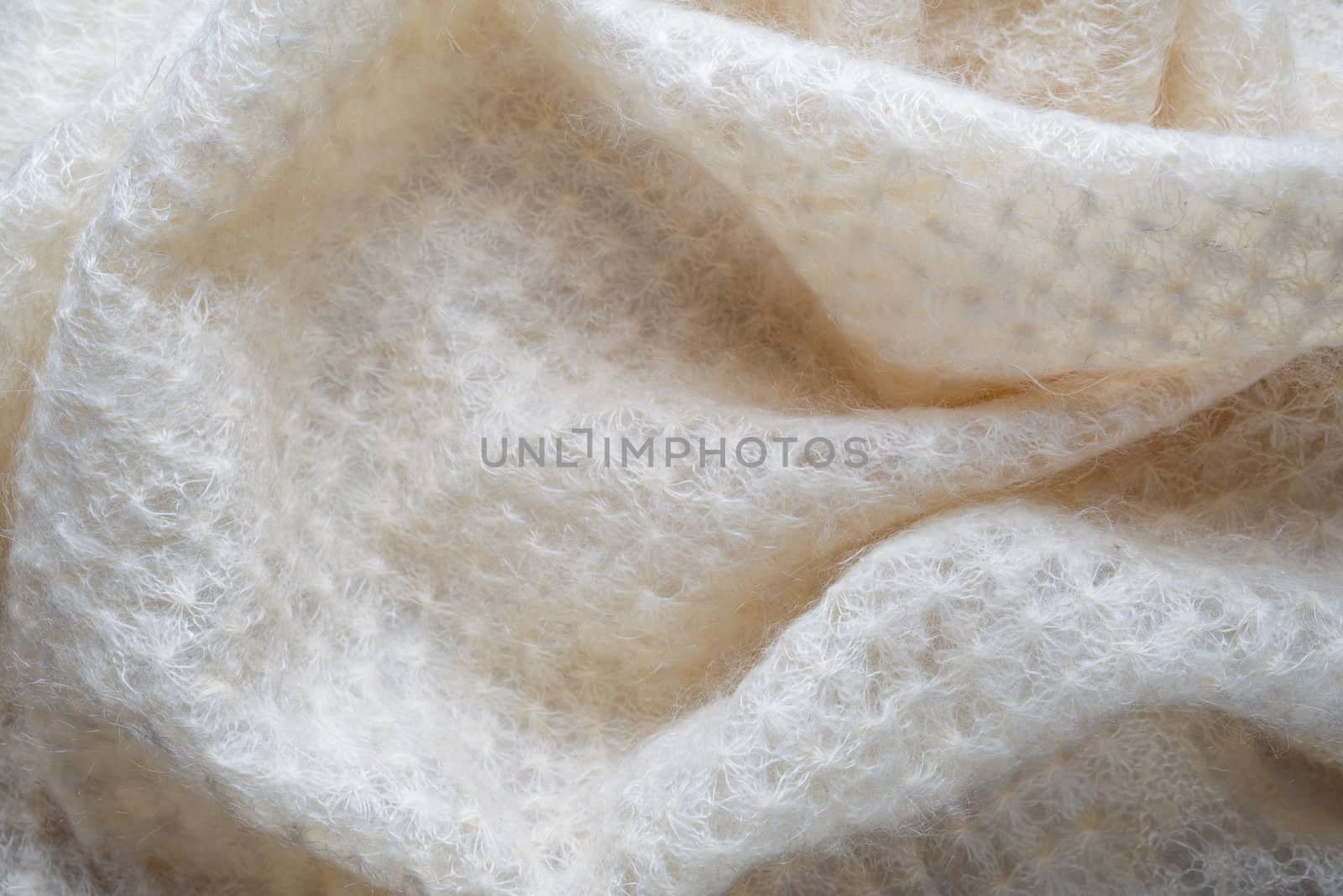Soft folds of a white goat fluff scarf to be used as background