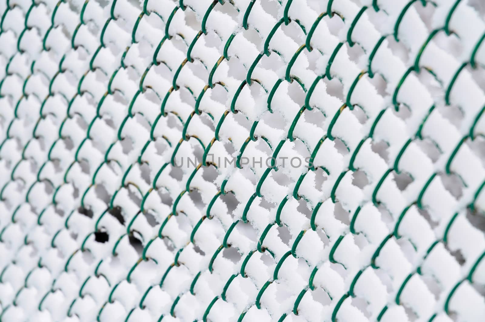 Wire fence with snow in cold winter