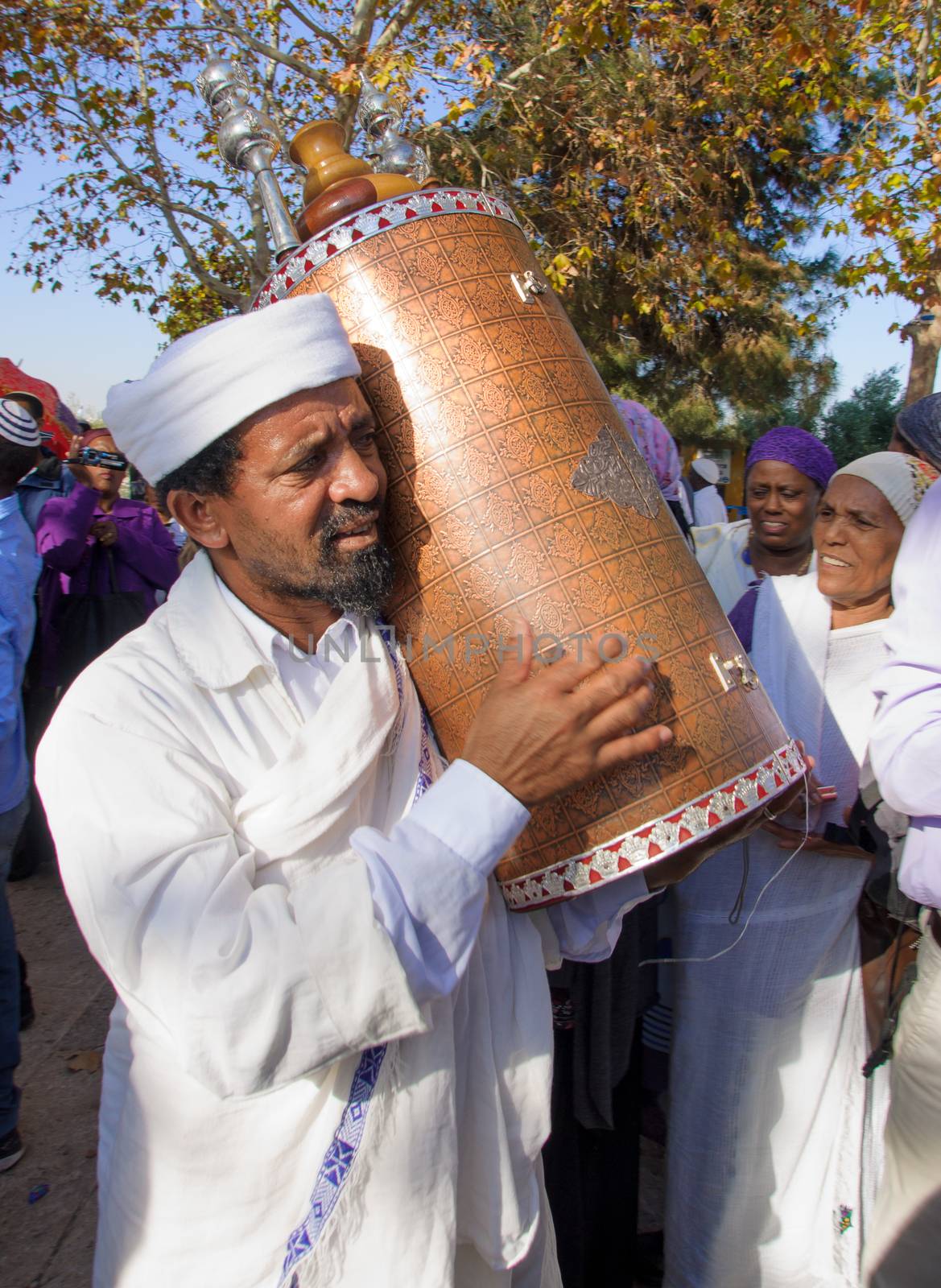 JERUSALEM - NOV 20, 2014: A Kes, religious leader of the Ethiopian Jews, carrying the holy torah book, at the end of the annual Sigd holiday prays, in Jerusalem, Israel