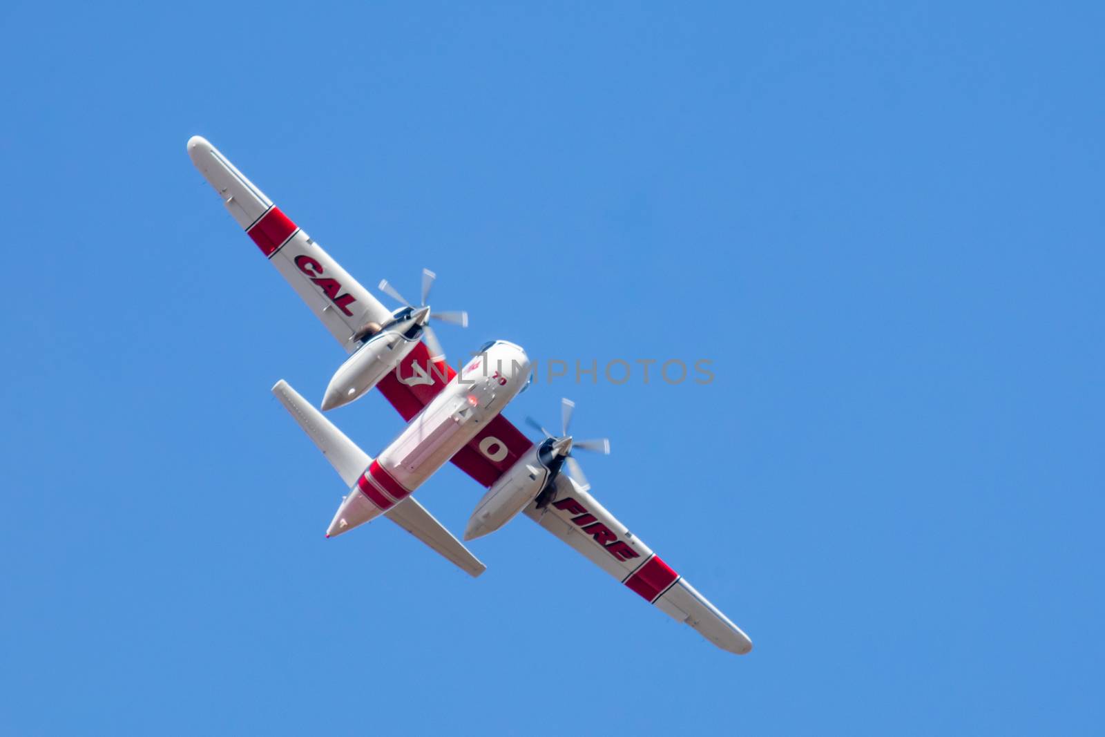Winchester, CA USA - June 14, 2020: Cal Fire aircraft preparingto drop fire retardant on a dry hilltop wildfire near Winchester, California. by Feverpitched
